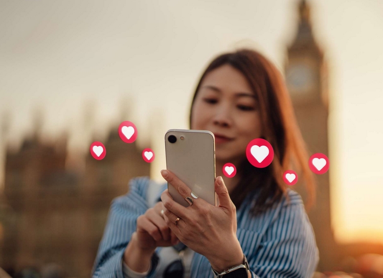girl sending hearts with phone